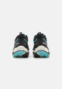 Black and turquoise trail running shoes with a cushioned sole, rugged treads, and reinforced heel support. Lightweight synthetic upper material.