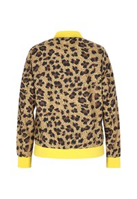Jas met luipaardprint, voorzien van een geweven textuur, gele kraag en manchetten, relaxte pasvorm, met donkerbruine en zwarte vlekken op een beige achtergrond.