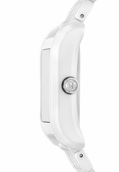 Vue latérale d'une montre-bracelet blanche avec une couronne métallique présentant un logo à motif sur un fond blanc.