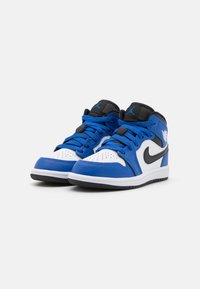 Mid-top sneakers with blue, black, and white synthetic leather upper, featuring perforated toe, black Nike swoosh, and rubber sole.