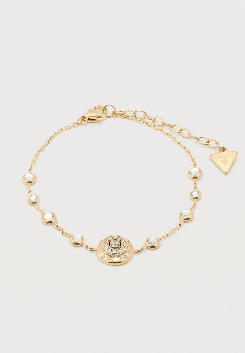 Λεπτό βραχιόλι αλυσίδας από χρυσό με μικρές διαυγείς πέτρες και κεντρικό κυκλικό μενταγιόν διακοσμημένο με κρυστάλλους, με ρυθμιζόμενο κούμπωμα και ετικέτα με εμπορικό σήμα.