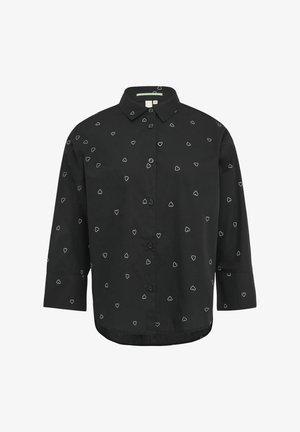 Chemise noire à boutons avec un motif de cœurs blancs, à manches longues et col classique. Confectionnée en tissu lisse avec une coupe ajustée.