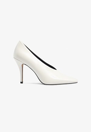 Witte pump met een spits toelopende neus, een slanke naaldhak en een gladde leren afwerking.