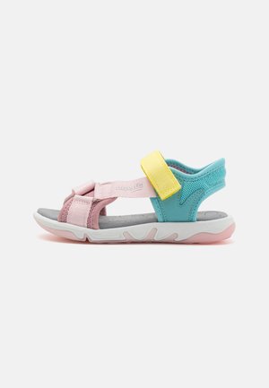 Colorful sandals featuring pink, blue, and yellow straps, Velcro closures, and a molded grey insole with a textured white outsole.