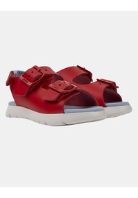 Sandali in pelle rossa con due cinturini regolabili, design open-toe e soletta imbottita blu chiaro su una suola bianca.