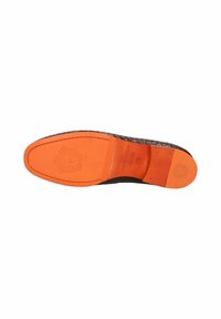 Lædersåle med vævet tekstur, med en orange gummibund. Markant branding præget på sålen.