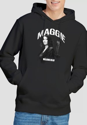 Person wearing black hoodie with graphic of a woman holding arrows and the text "MAGGIE" and "The Walking Dead."