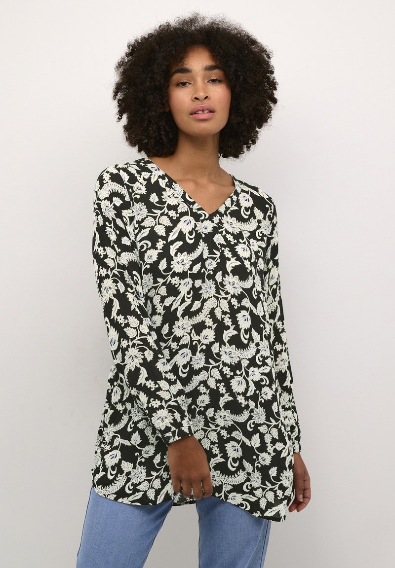 Blusa a maniche lunghe con scollatura a V nera, con motivi floreali e foglie bianchi; tessuto leggero con vestibilità rilassata.