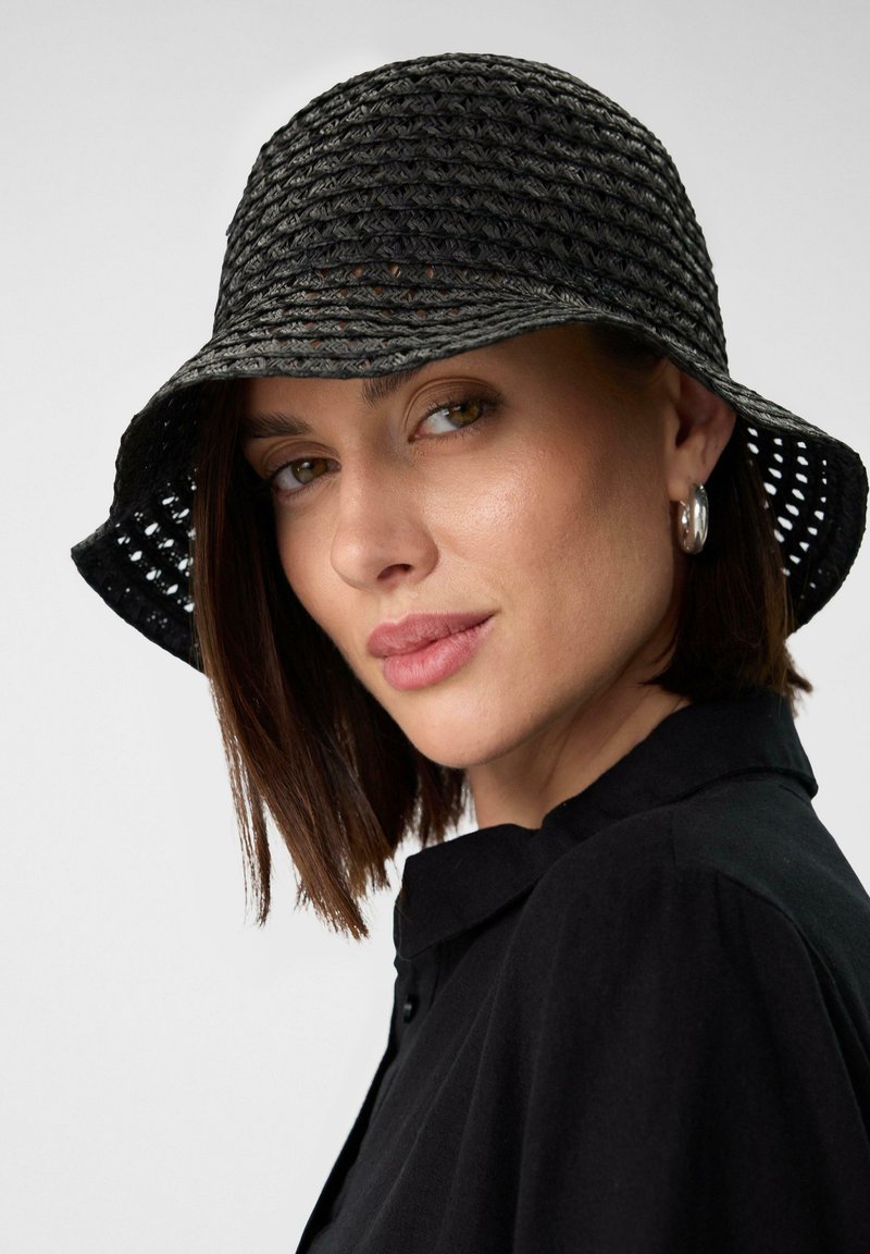 Black woven bucket hat with a wide brim, featuring a textured pattern and open weave. Details include light gray accents and a soft finish.