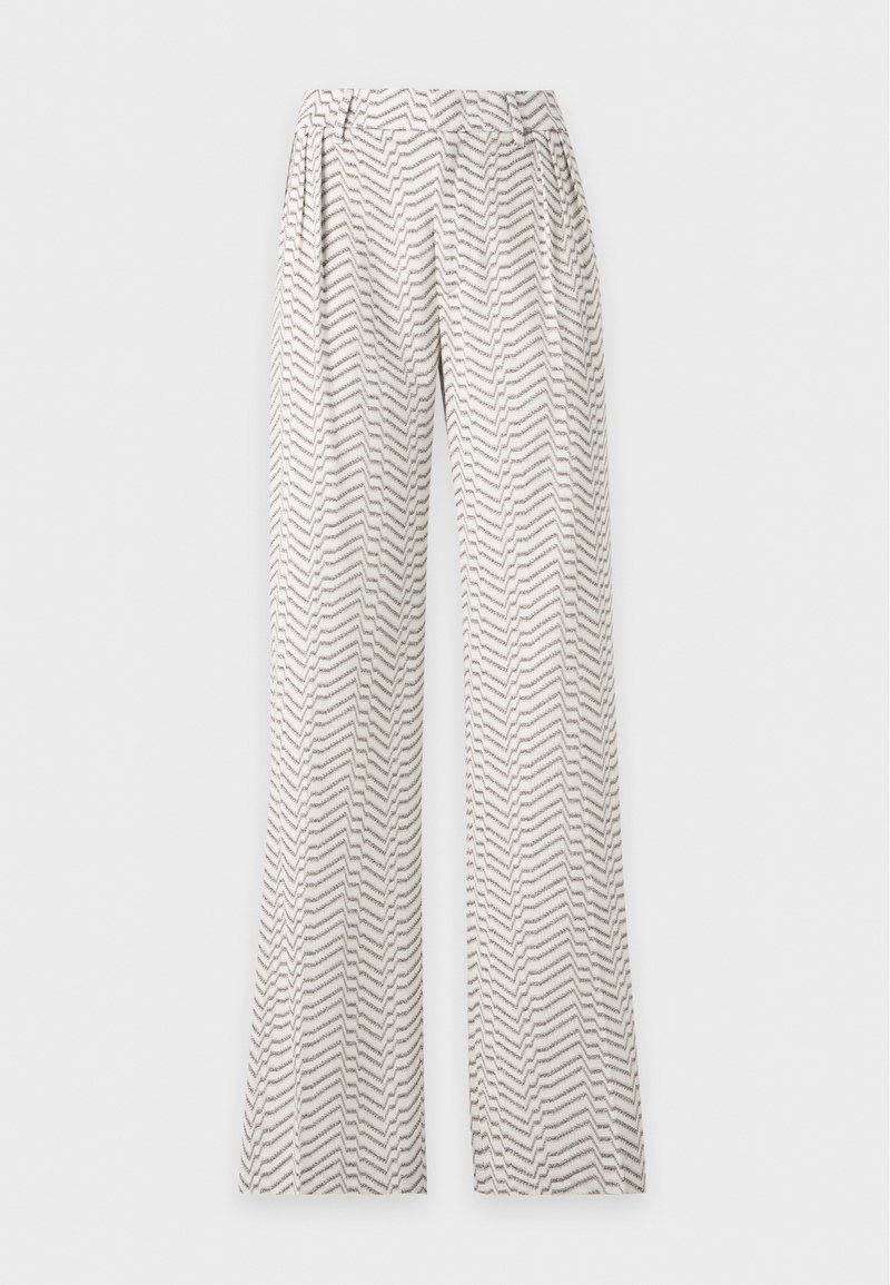 Pantalon blanc à coupe large avec taille haute et motif zigzag gris, présentant des plis à l’avant et des poches latérales.