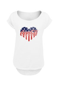 White short-sleeve shirt with a heart-shaped American flag design and red Coca-Cola logo centered on the chest.
