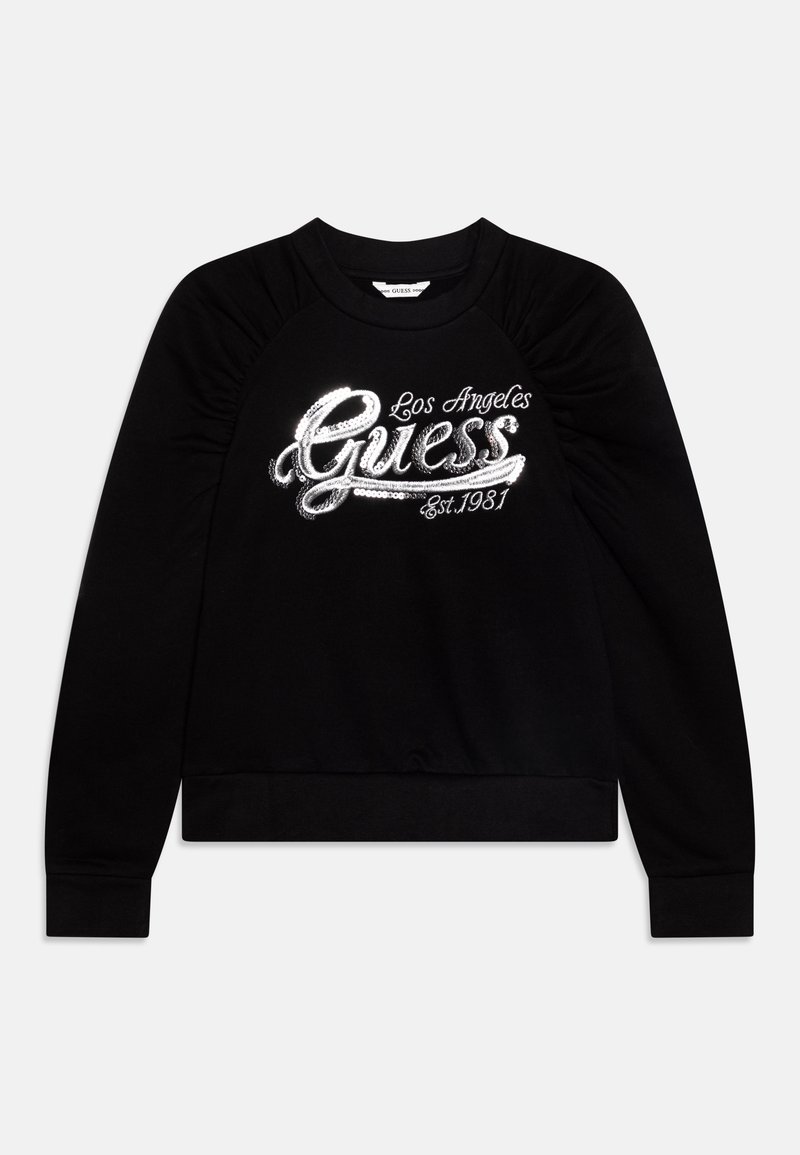 Sweat-shirt noir à manches longues avec épaules volantées et texte en sequins argentés brillants "Guess Los Angeles Est. 1981" sur le devant.