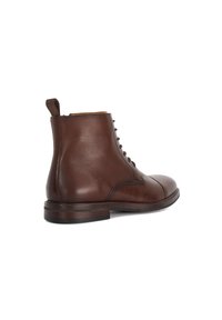 Brown leather ankle boot with a rounded toe and lace-up design. Features a pull tab and textured details near the eyelets.