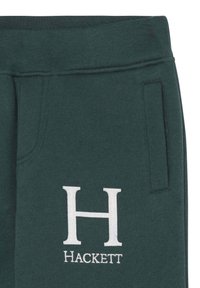 Gröna bomullsjoggers med elastisk midja, sidoficka och vitt broderat "H"-logotyp med "Hackett" under. Mjuk textur.