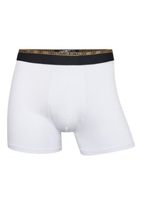 Hvide boxer shorts lavet af bomuld med en sort talje, der har "Cristiano" og "CR7" i guldtryk. Glat tekstur, tætsiddende design.