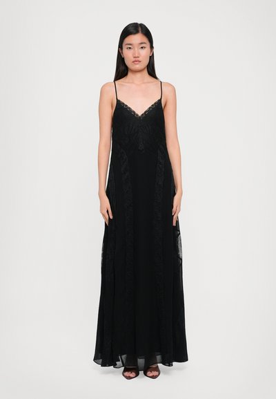 Robe maxi noire avec un décolleté en V bordé de dentelle, des fines bretelles et une silhouette en A avec des accents en dentelle le long des côtés.