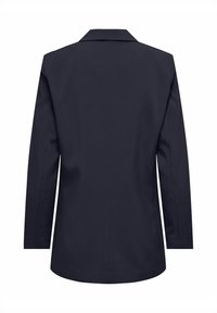 Jūras spēku zils žakets ar klasisku atlocītu apkakli, garām piedurknēm un taisnu piegriezumu. Izgatavots no gludas auduma, ar aizmugures ventiļu un tīrām, pielāgotām līnijām.