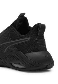 Schwarzer Sportschuh mitMesh-Obermaterial, strukturierten Details und abgerundetem Absatz. Verfügt über einen gepolsterten Kragen und eine kleine transparente Air-Einheit.