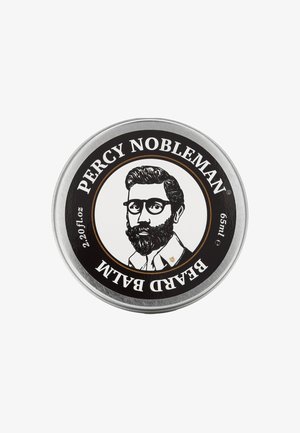Contenitore metallico circolare con un'etichetta nera che presenta un'illustrazione in stile vintage di un uomo con barba e occhiali; il testo recita "PERCY NOBLEMAN BEARD BALM."