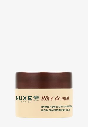 Nuxe Rêve de miel ansigtsbalsam krukke med brun låg og beige beholder, mærket ultra beroligende ansigtsbalsam på fransk og engelsk.