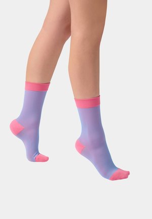 Legs wearing mid-calf ribbed socks with lavender body and pink cuffs, heels, and toes, shown against a plain light background.