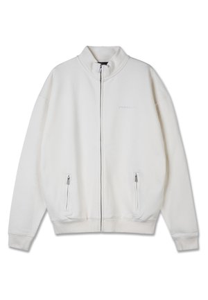 Jachetă ușoară, cu fermoar, din material fleece de culoare albă. Are un guler înalt, buzunare laterale cu fermoar și o croială lejeră.