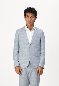 Light blue checked suit jacket made from textured fabric. Features notched lapels, two buttons, and two front pockets. Paired with matching pants.