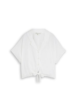 Chemise blanche à manches courtes boutonnée avec col et nœud devant, présentée sur un fond blanc uni.