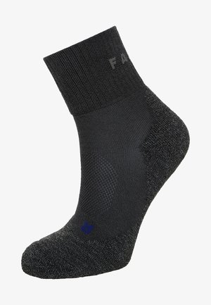 Black ankle sock with reinforced heel and toe, textured fabric, ribbed cuff, and a small blue logo near the base.