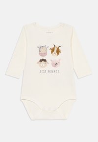 Långärmad babybodysuit i bomull i krämfärgad med djurillustrationer och texten "BÄSTA VÄNNER." Har tryckknapp i botten.
