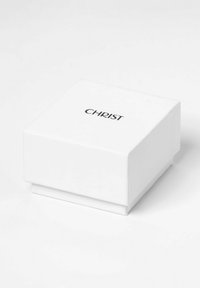 Weißer quadratischer Schmuckkasten mit glänzender Oberfläche, der das Wort "CHRIST" in schwarzer Serifenschrift auf der Oberseite zeigt. Keine zusätzlichen Verzierungen.