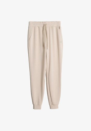 Pantaloni della tuta beige realizzati in tessuto morbido, caratterizzati da una vita elastica con cordino, tasche laterali e orli a costine.