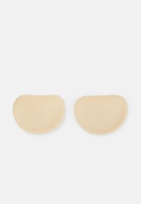 Beige silicone pads with a smooth texture and rounded edges, designed in a kidney shape, featuring a matte finish.