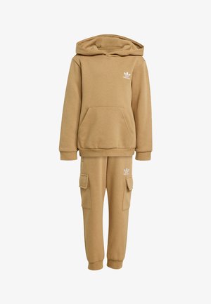 Tan hoodie and cargo pants set made of a textured fabric, featuring a front pocket, ribbed cuffs, and a white logo on the chest and thigh.