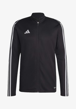 Chaqueta deportiva negra con cremallera completa, que presenta tres franjas blancas a lo largo de las mangas y un pequeño logotipo reflectante en el pecho.