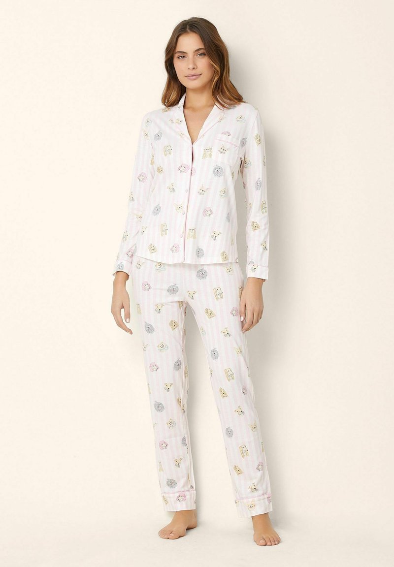 Set de pijama din bumbac cu un model cu dungi roz, prezentând ilustrații cu animale. Tops cu mânecă lungă și pantaloni lungi cu manșete.