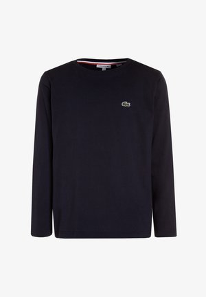 Schwarzes Langarmshirt mit Rundhalsausschnitt und kleinem grünem Krokodil-Logo auf der linken Brust.