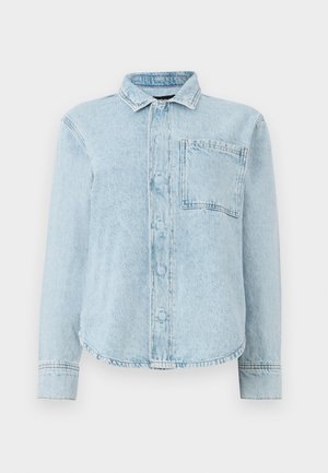Hele sinine denimpusa pikkade varrukatega, ees nupukesed, üks rinnaeper, terav krae ja kergelt kaardus äärega.