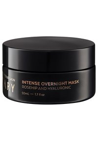 Bocal rond noir avec finition mate, texte doré affichant le nom et les détails du produit. Capacité de 50 mL, conçu pour une utilisation sur la peau pendant la nuit.