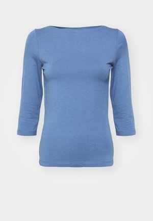 Blaues Langarmoberteil aus weichem Stoff mit Rundhalsausschnitt und taillierter Passform. Hat eine glatte Textur und Naht entlang dem Saum.