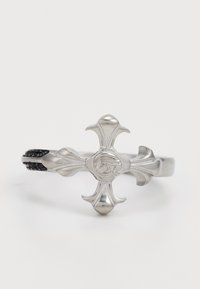 Silver ring featuring a cross design with flared ends, intricate engraving, and a textured black band, combining metal and fabric elements.