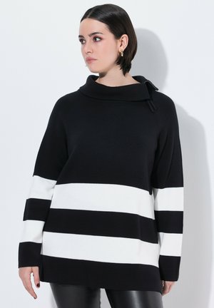 Pull-over rayé noir et blanc avec col montant, manches longues, texture côtelée et coupe décontractée. Motif horizontal distinctif.