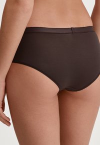 Brown high-waisted briefs with a smooth texture, featuring a seamless waistband and precise stitching along the leg openings.