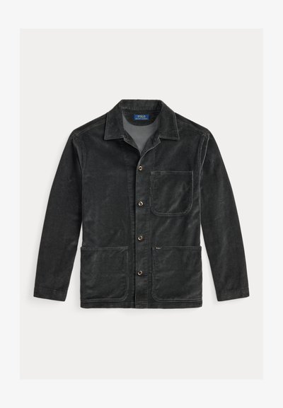 Black corduroy jacket with a collar, two front pockets, and a button closure. Features a single chest pocket and subtle texture.