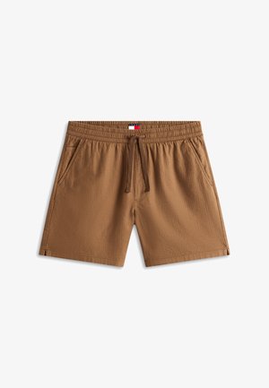 Bruine shorts met elastische taille en aantrekkoord, zijzakken en een klein rechthoekig logopatch in het midden van de tailleband.