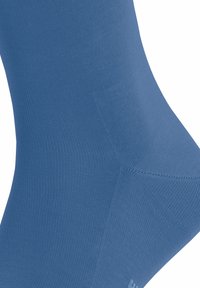 Blaue, knielange Socke aus weichem, strukturiertem Stoff, mit einer glatten Oberfläche und ripp design sowie subtilen Nähdetails.