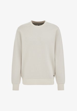 Svijetlo bež majica s okruglim vratom, izrađena od teksturirane tkanine. Ima duge rukave i rebraste manžete i rub. Mali logo naglasak sa strane.