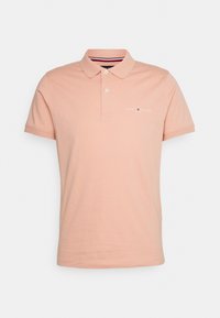 Poloshirt i blød ferskenfarvet bomuld med krave, korte ærmer og et lille hvidt logo på brystet. Klassisk pasform.