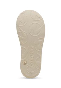 Rubber shoe sole in beige with a textured pattern featuring circular logos and the brand name "Naturno" embossed in the center.