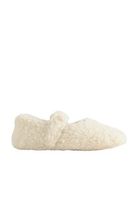 Chausson doux couleur crème avec une texture duveteuse et un petit détail boucle sur le côté, vu de l'intérieur.